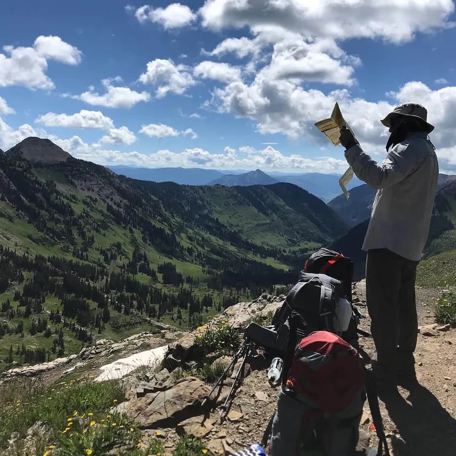 Eric reading a map on a ridgeline